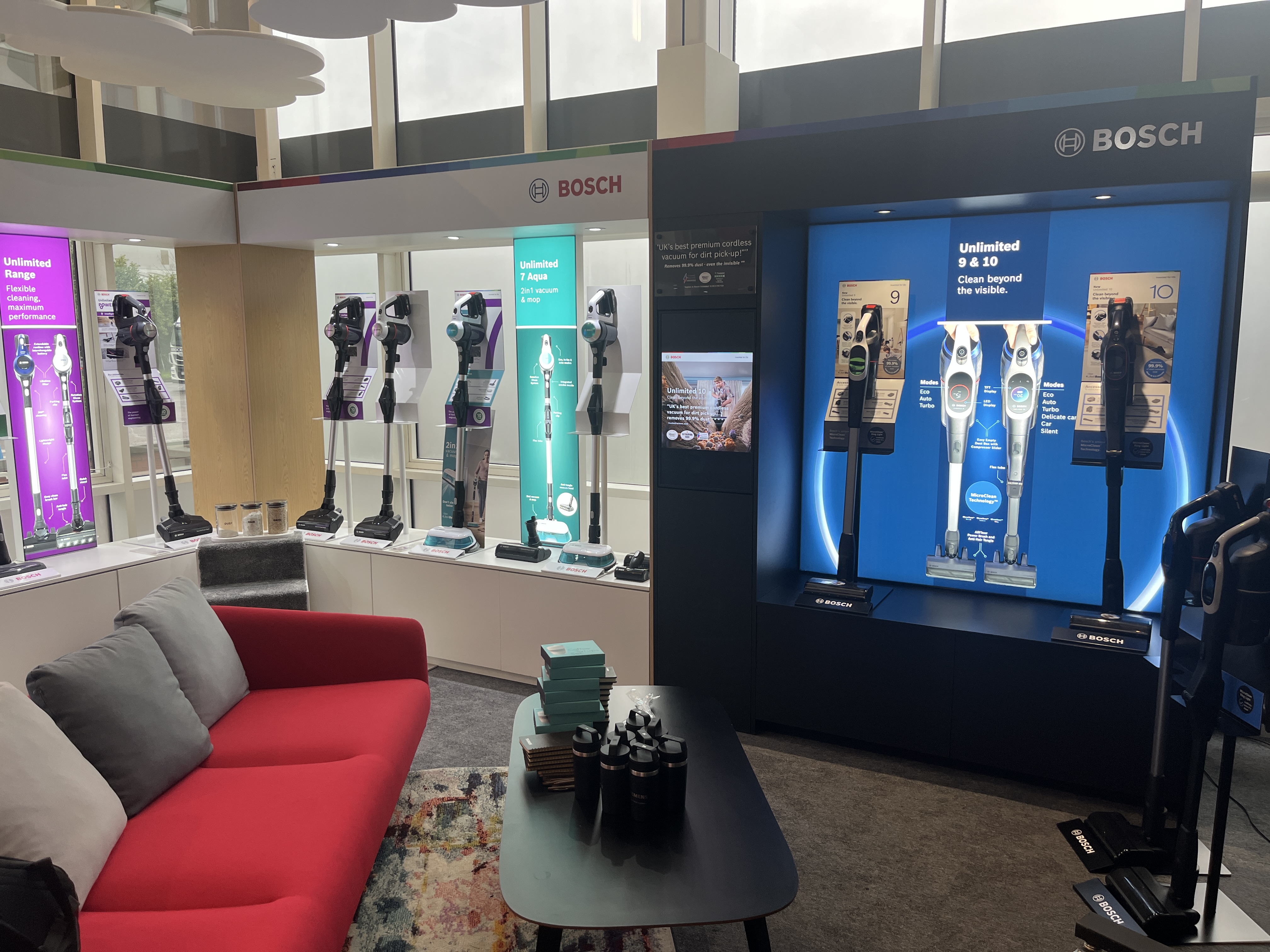 Bosch SDA HQ showroom with cordless vacuum cleaner display wall and backlit product bays